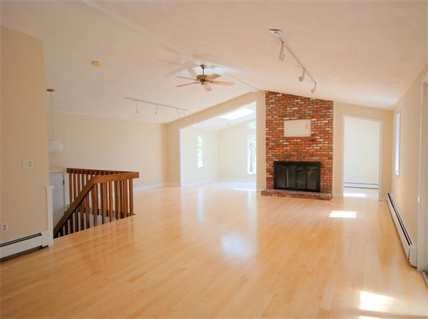 9 Alpine Road Wayland, MA 01778 - Photo 5 of 16 a view of an empty room with a fireplace