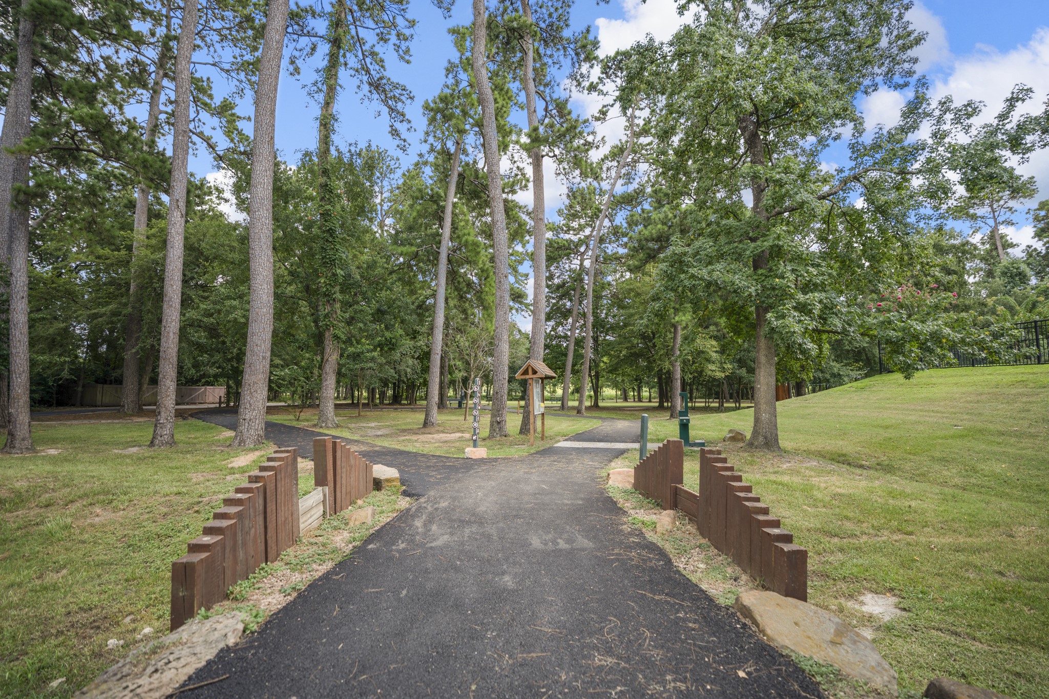 19106 South Rim Trail Spring, TX 77388 - Photo 48 of 50 Nearby wooded pathways add to the lifestyle appeal around Cypress Forest, giving buyers another easy way to enjoy time outdoors close to home. Whether it’s a morning walk, an afternoon reset, or a simple way to take in the established surroundings, this setting helps show how 19106 S Rim Trail connects to more than just the home itself — it connects to the neighborhood around it.