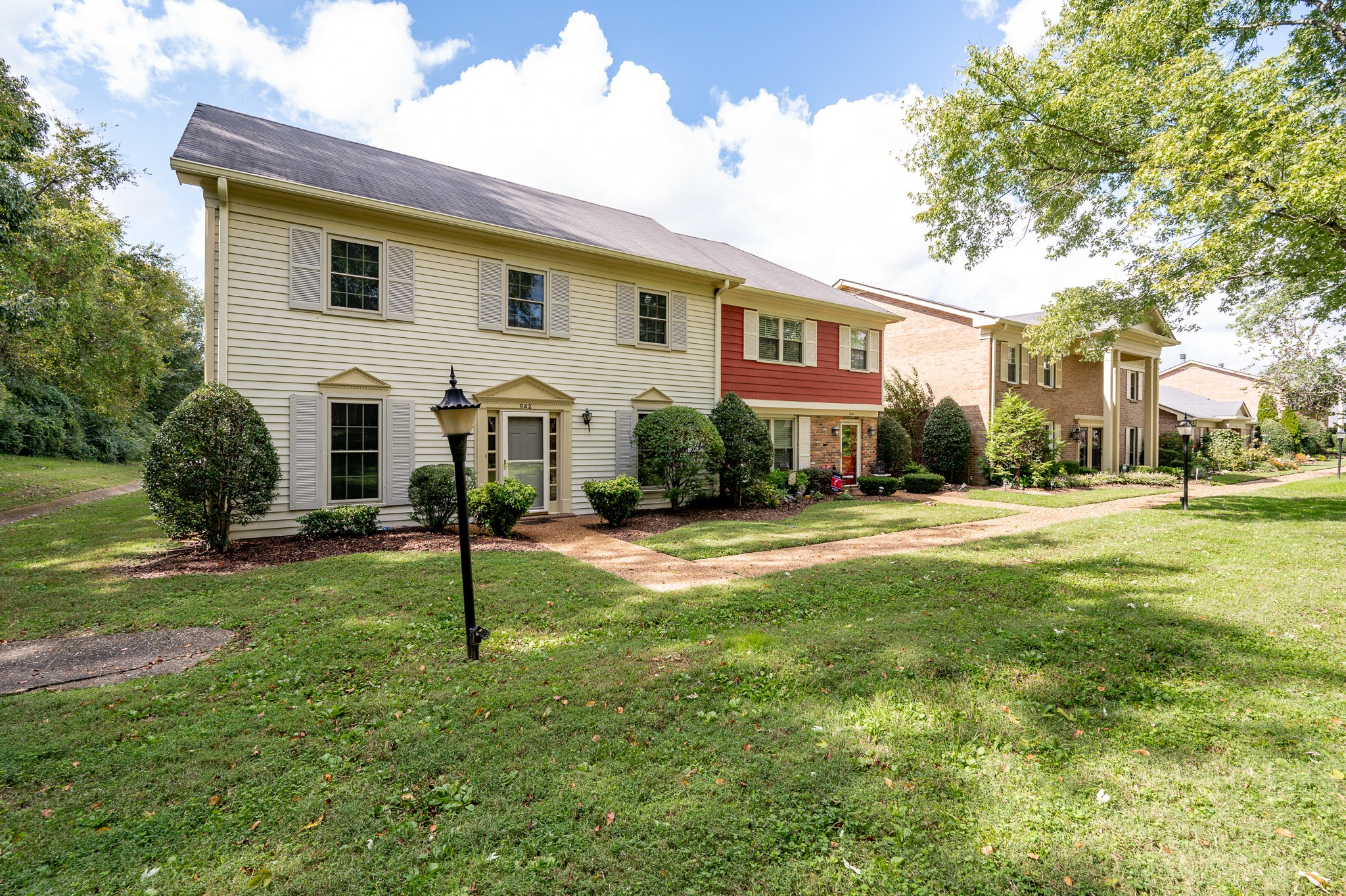 942 General George Patton Road Nashville, TN 37221 - Photo 1 of 23 a view of a white house with a yard and plants