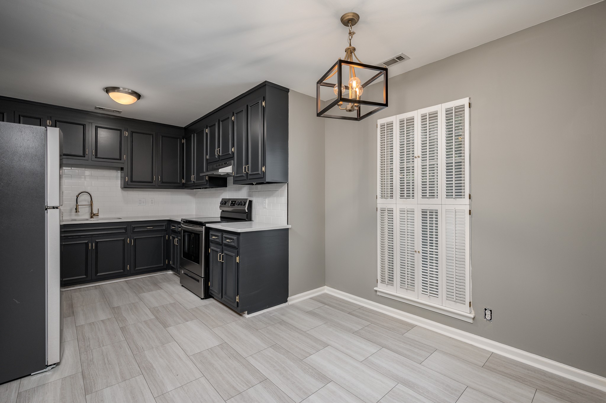 942 General George Patton Road Nashville, TN 37221 - Photo 11 of 23 a kitchen with stainless steel appliances granite countertop a refrigerator a sink dishwasher a stove and white cabinets with wooden floor