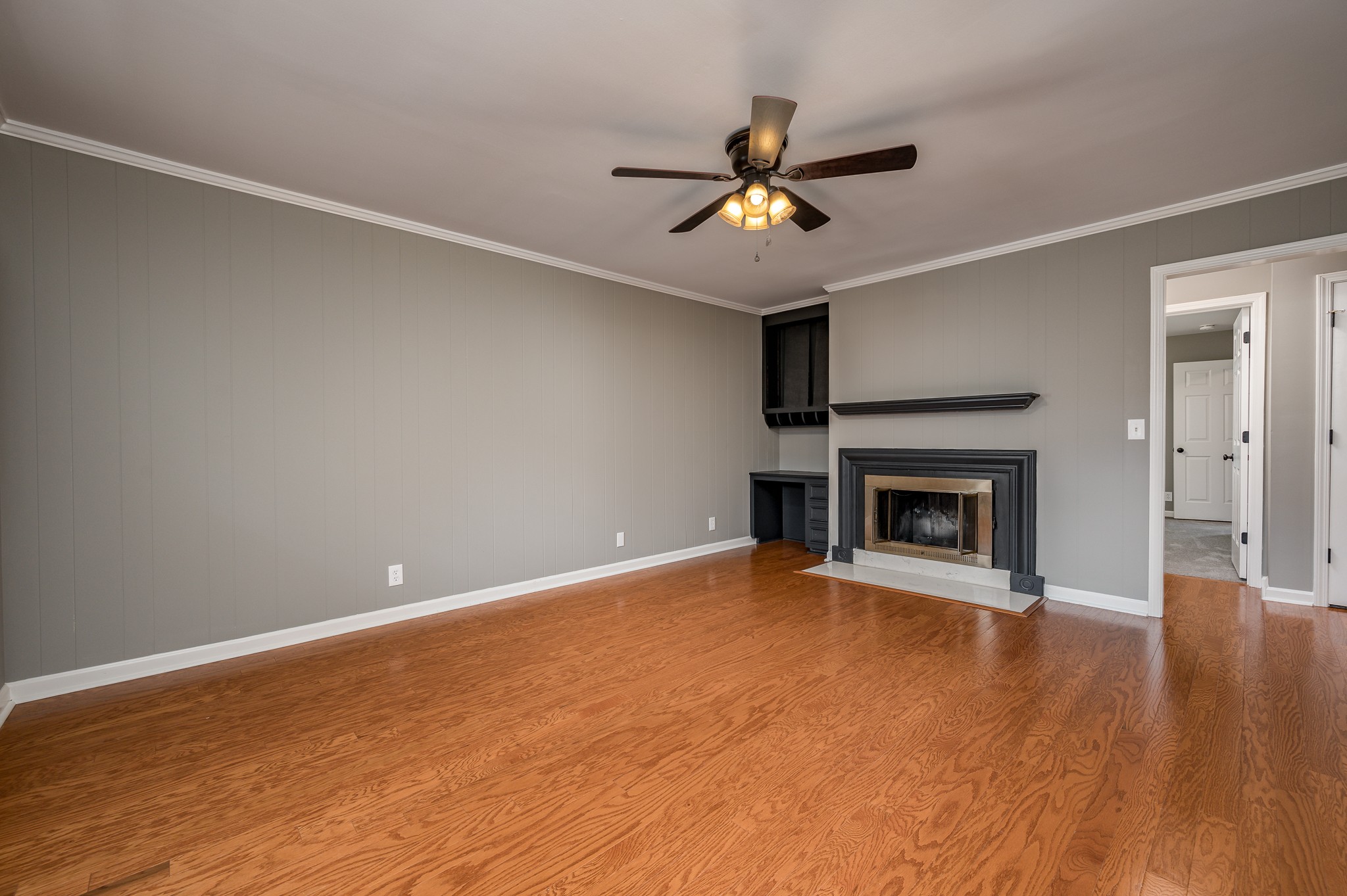 942 General George Patton Road Nashville, TN 37221 - Photo 12 of 23 a view of an empty room with wooden floor a fireplace and a window