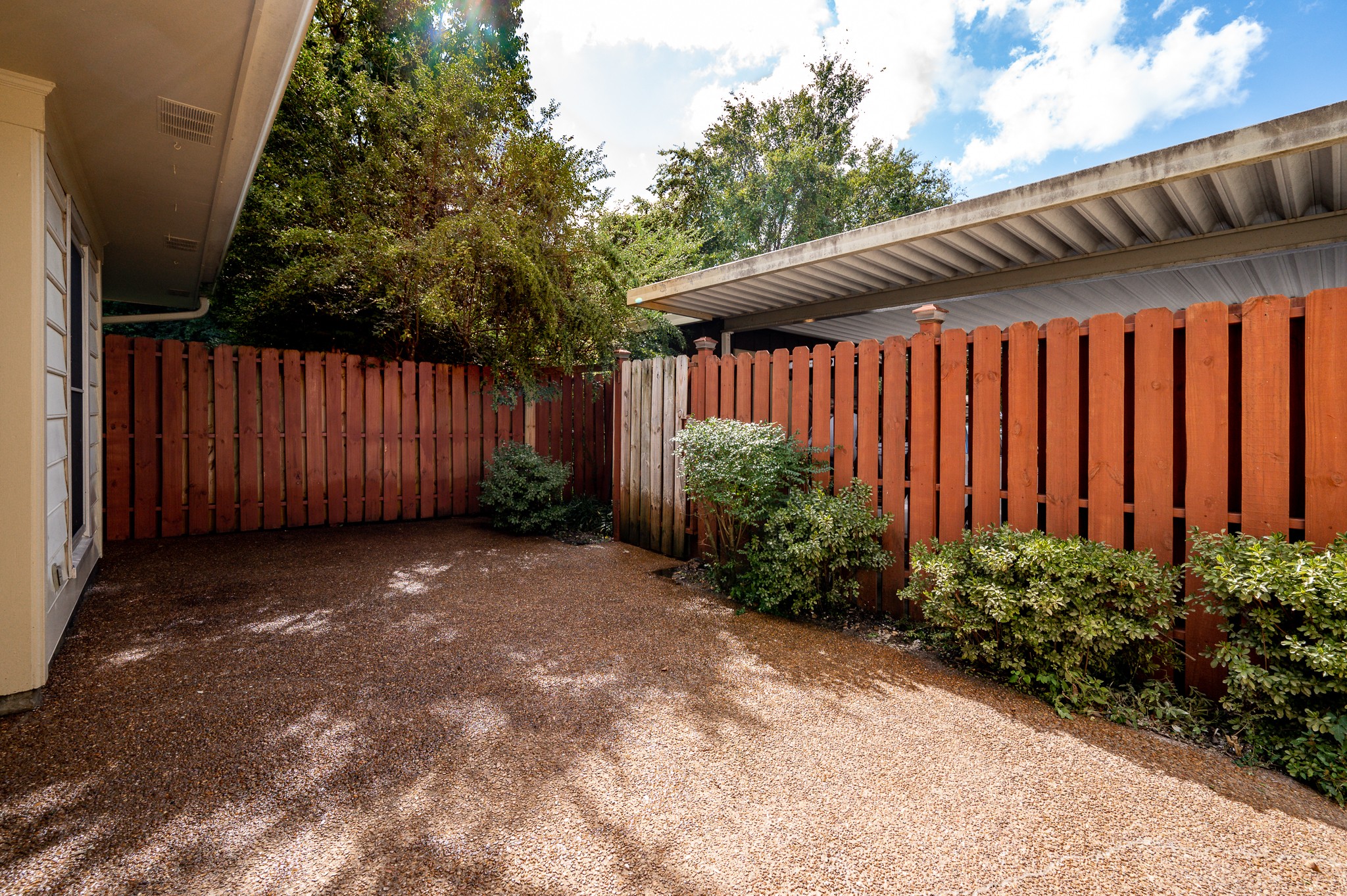 942 General George Patton Road Nashville, TN 37221 - Photo 22 of 23 a view of a backyard with potted plants and wooden fence