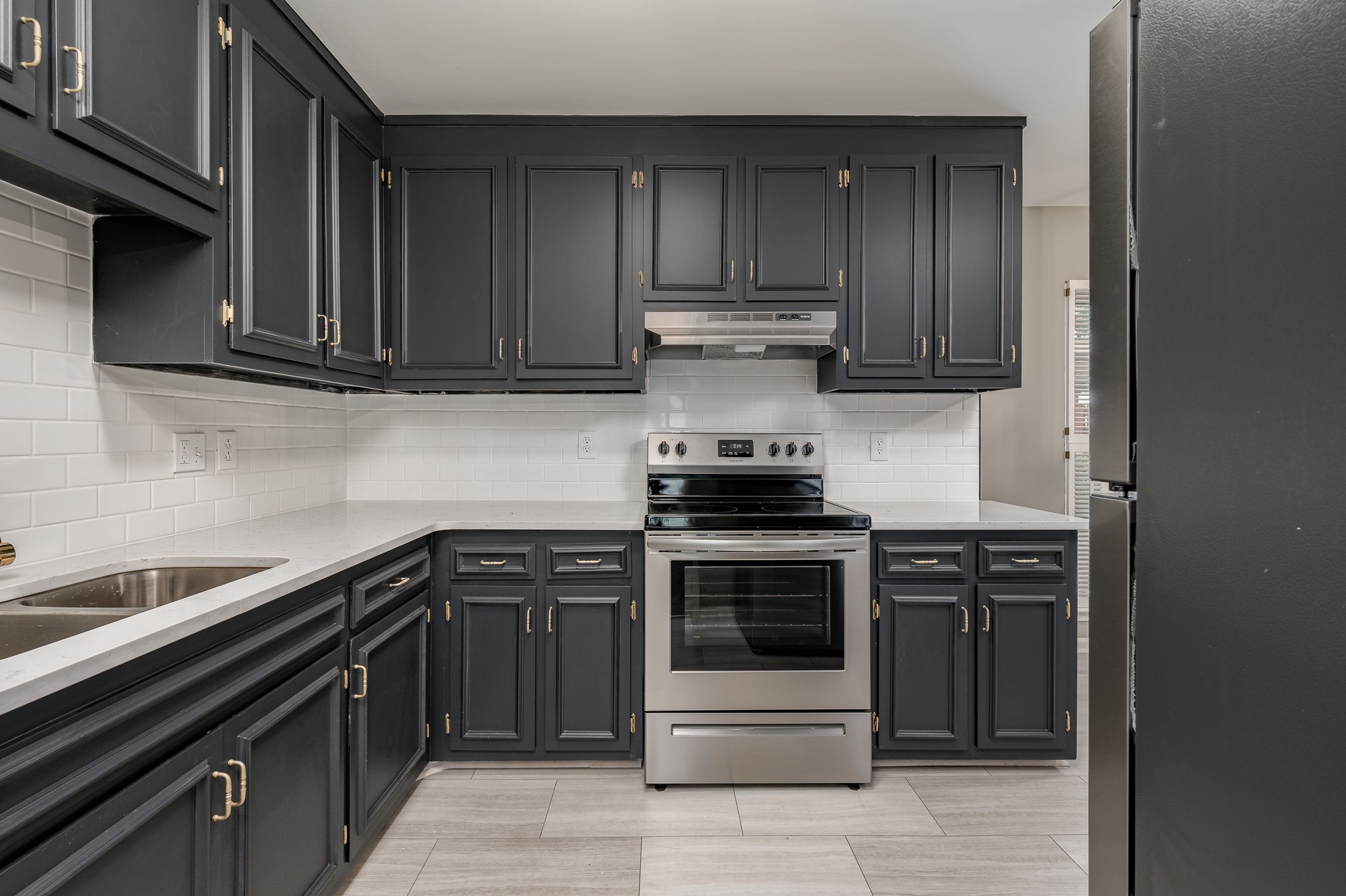 942 General George Patton Road Nashville, TN 37221 - Photo 8 of 23 a kitchen with a stove and a sink