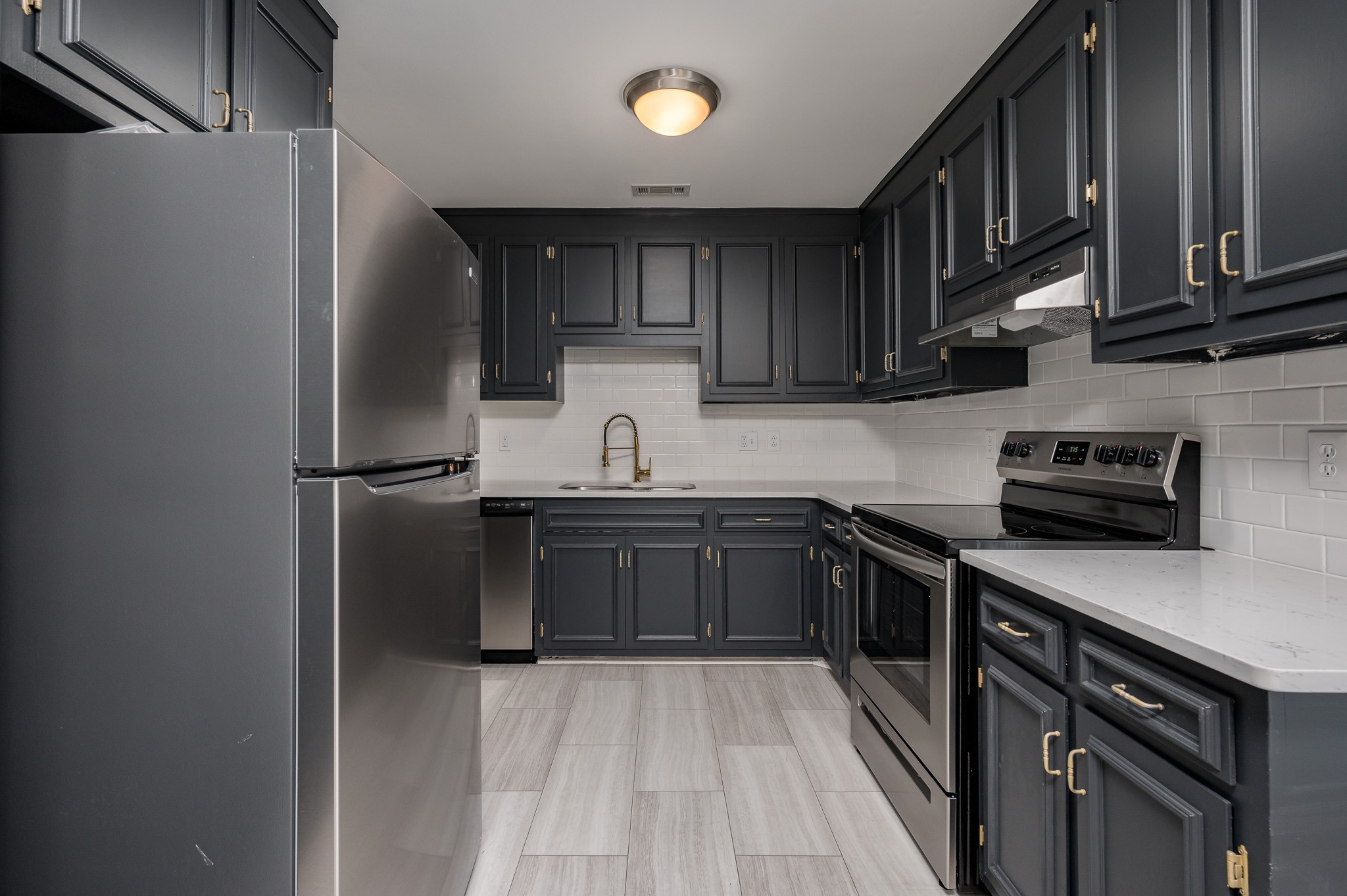 942 General George Patton Road Nashville, TN 37221 - Photo 9 of 23 a kitchen with stainless steel appliances granite countertop a refrigerator a sink dishwasher a stove top oven a refrigerator and cabinets