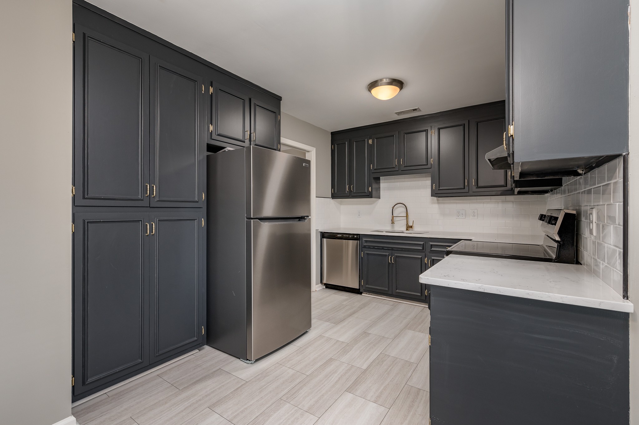 942 General George Patton Road Nashville, TN 37221 - Photo 10 of 23 a kitchen with a refrigerator sink and cabinets