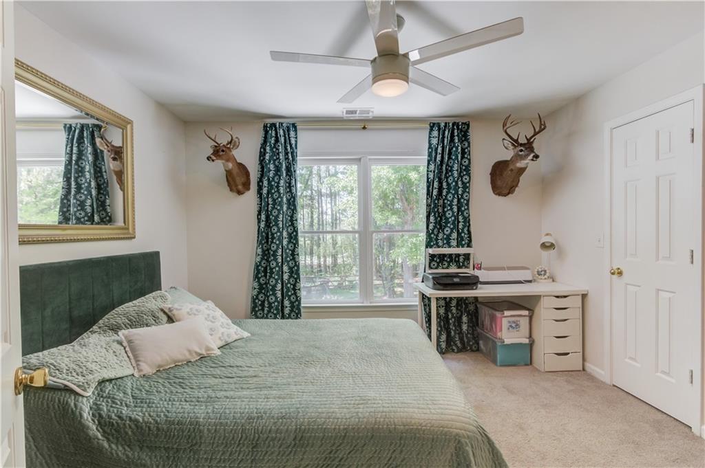 2310 Olde Hickory Place Monroe, GA 30656 - Photo 29 of 46 a bedroom with a bed and a chandelier