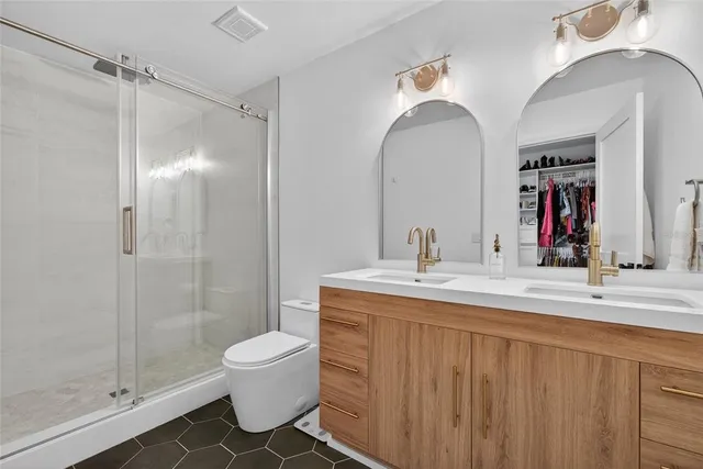 a bathroom with a double vanity sink and a mirror