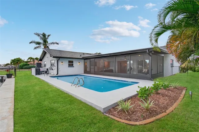 a view of a house with a yard and potted plants