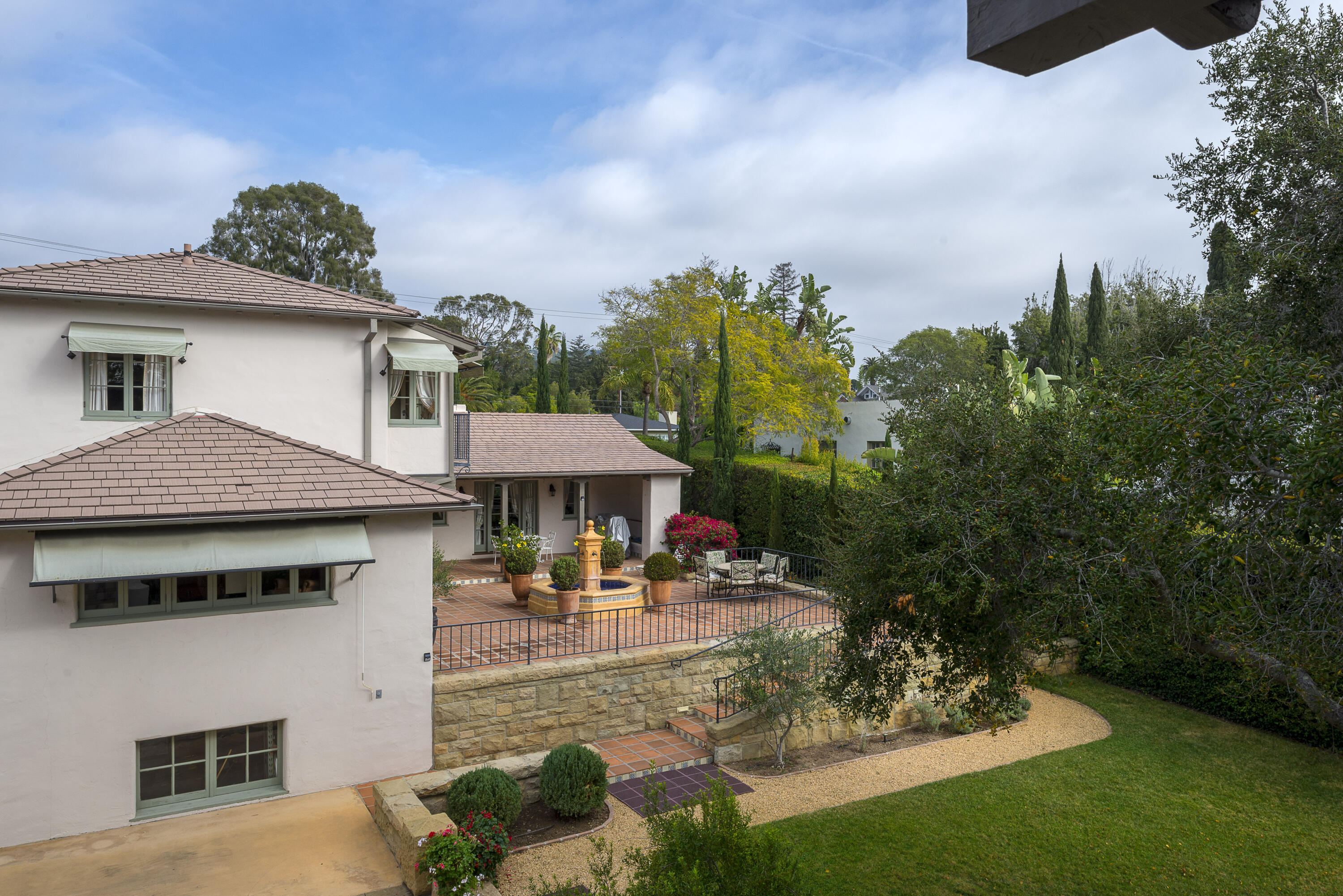 2311 Santa Barbara Street Santa Barbara, CA 93105 - Photo 19 of 20 a view of a white house with a fountain in a yard