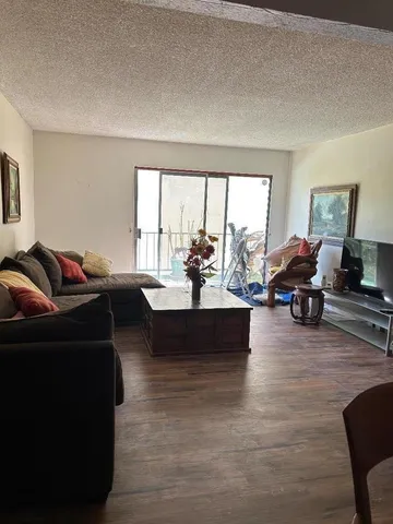 a living room with furniture window and wooden floor
