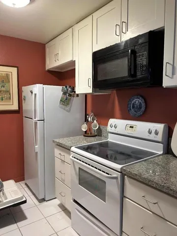 a kitchen with a stove microwave and refrigerator