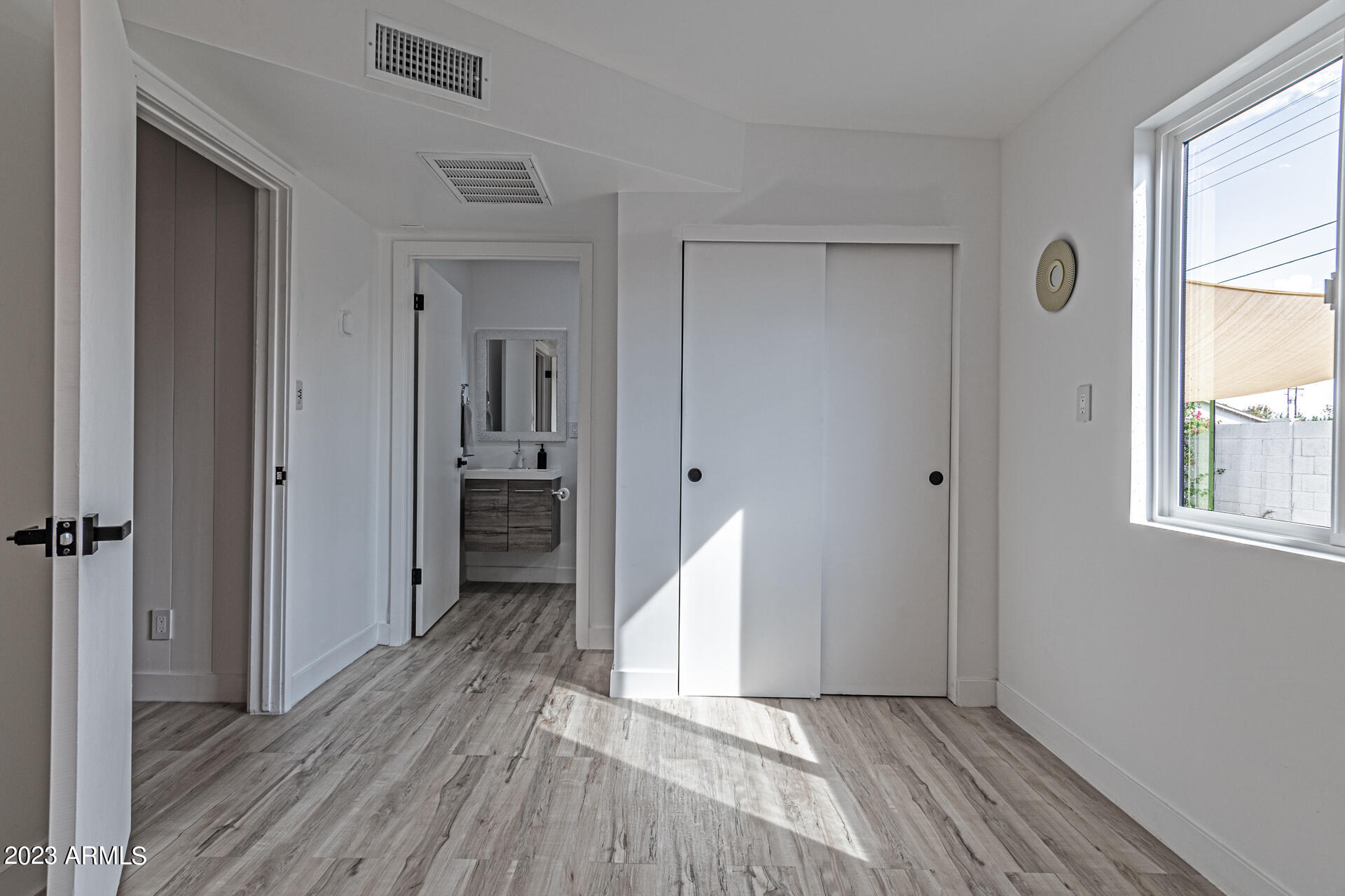 1539 West Puget Avenue Phoenix, AZ 85021 - Photo 21 of 27 wooden floor in an empty room with a window