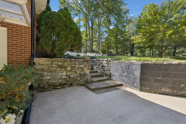a kitchen with granite countertop cabinets a refrigerator a dining table and chairs