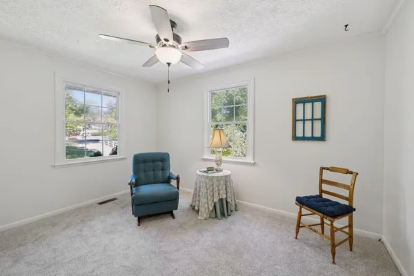 a bedroom with a bed a couch and painting on the wall