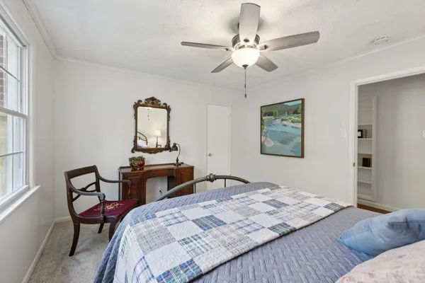 a view of a livingroom with workspace and a window