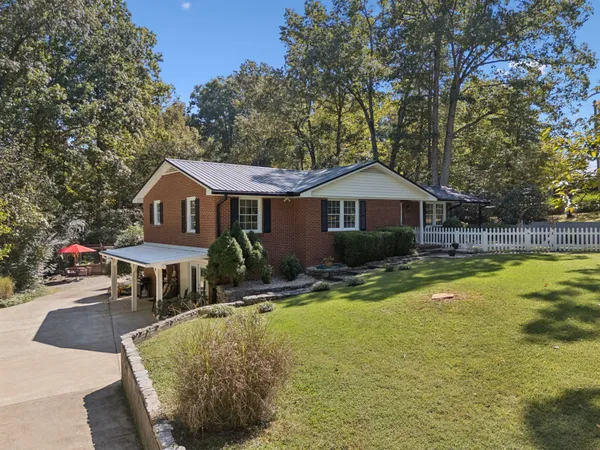 a front view of a house with swimming pool and porch