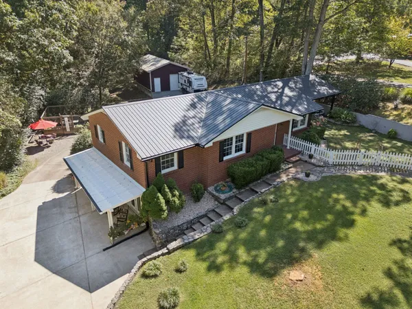 an aerial view of a house with a yard basket ball court and outdoor seating