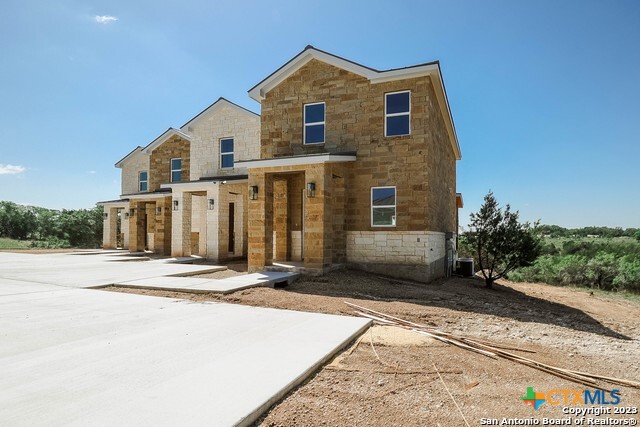 289 Star Grass, Unit 3 Spring Branch, TX 78070 - Photo 3 of 40 a front view of a house with a yard