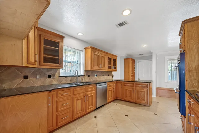 a kitchen with stainless steel appliances a stove and a refrigerator