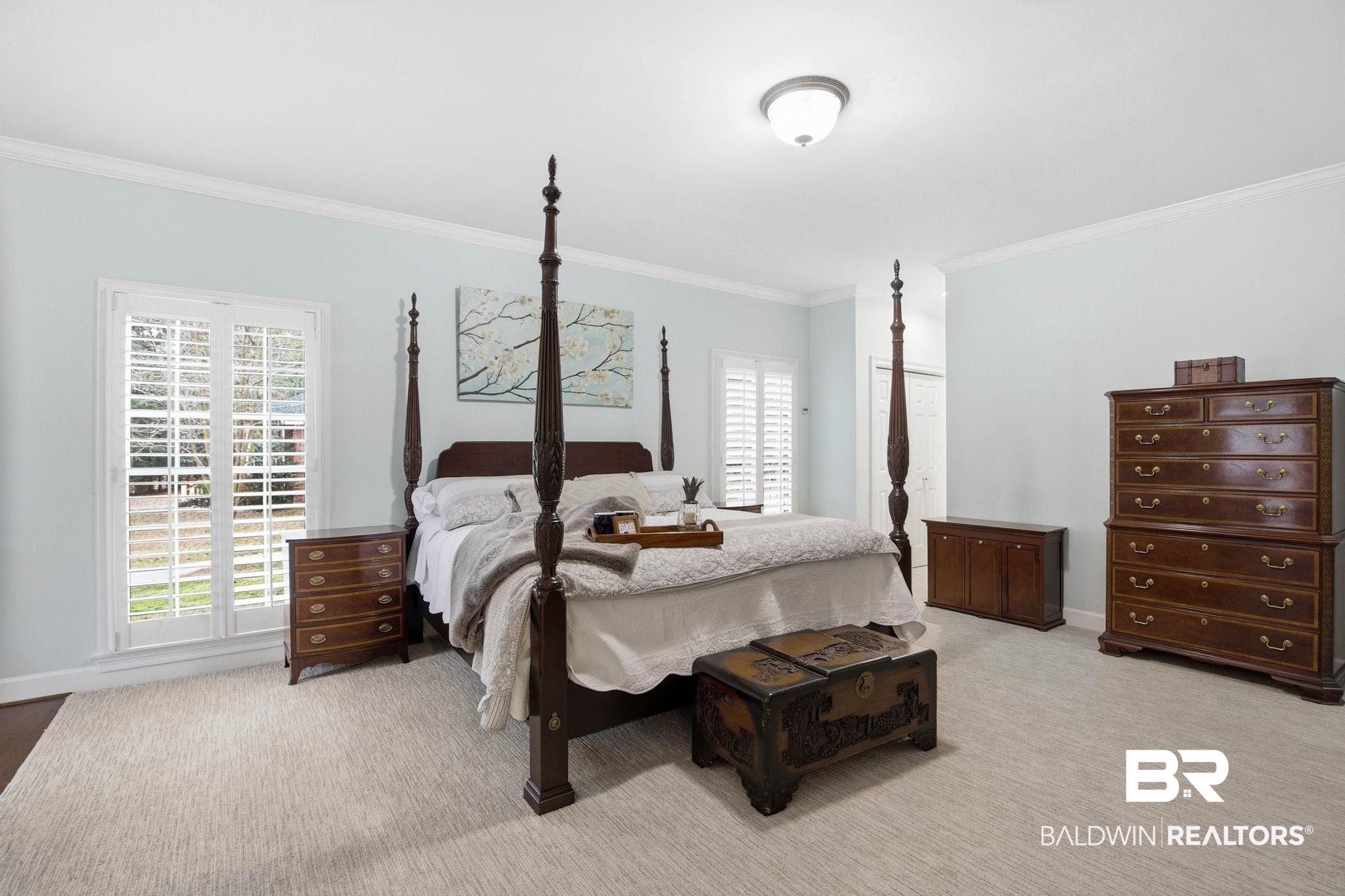 31515 Rhett Drive Spanish Fort, AL 36527 - Photo 28 of 100 The oversize primary suite has TWO walk in closets, a coat closet, a sitting area with an electric fireplace, crown molding, a large linen closet, and plantation shutters. The primary suite measures 16' 2" x 34' 6"