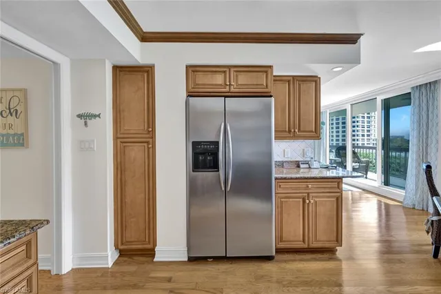 a kitchen with granite countertop a refrigerator and a sink