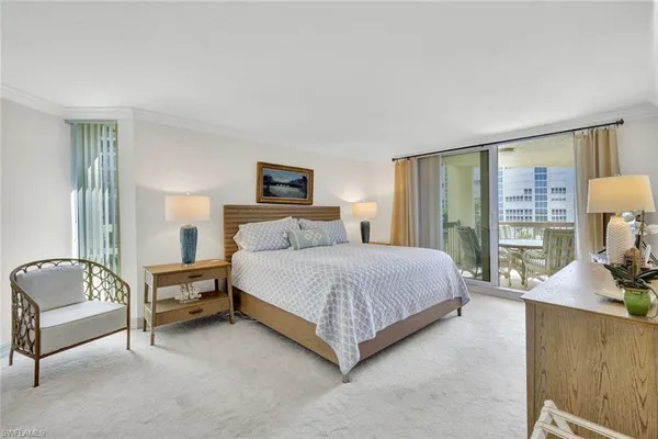 a bedroom with a bed and large window