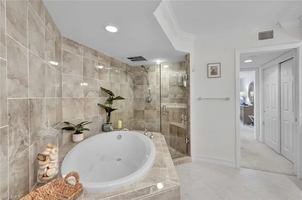 a bathroom with a tub and shower