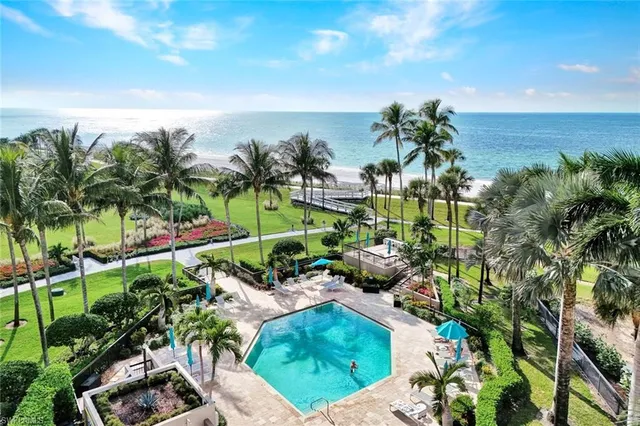 a view of a garden with a lake in the back