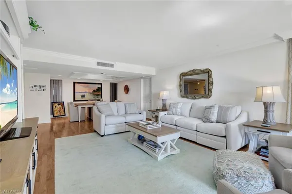 a living room with furniture and a lamp