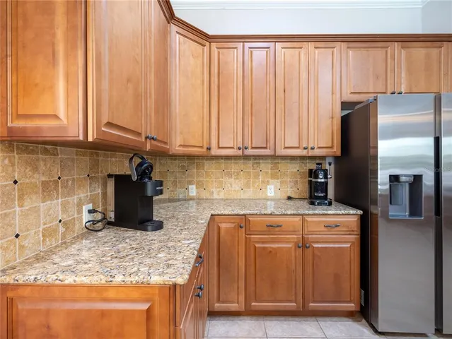 a kitchen with stainless steel appliances granite countertop a refrigerator sink and cabinets