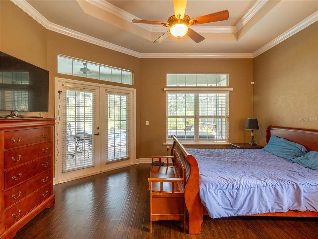 1488 Southwest 84th Terrace Gainesville, FL 32607 - Photo 14 of 31 a spacious bedroom with a bed and wooden floor