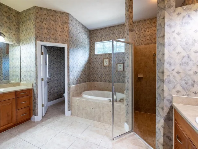 a bathroom with a granite countertop sink a mirror and a shower