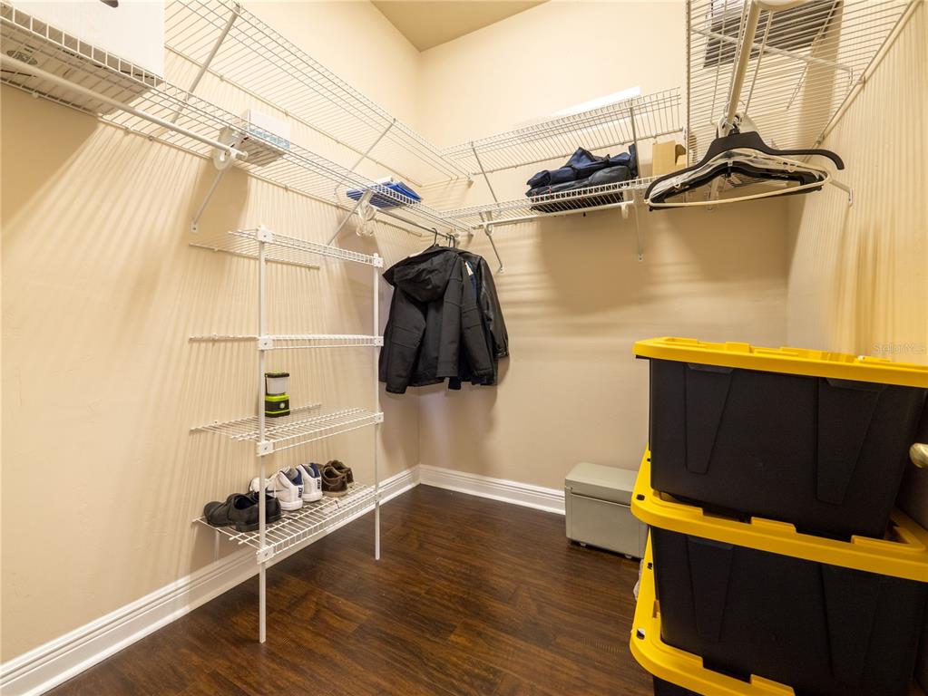 1488 Southwest 84th Terrace Gainesville, FL 32607 - Photo 18 of 31 a view of walk in closet with clothes and shoes