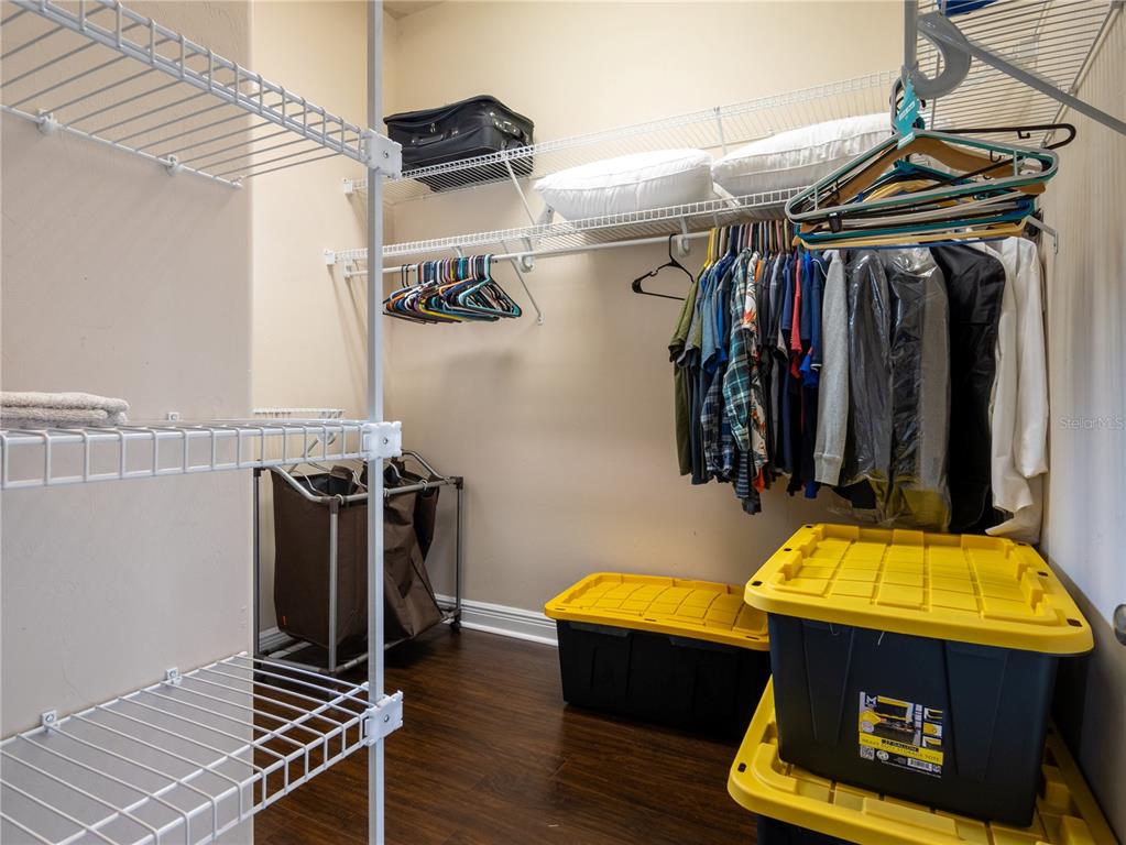 1488 Southwest 84th Terrace Gainesville, FL 32607 - Photo 19 of 31 a view of walk in closet with clothes and shoes