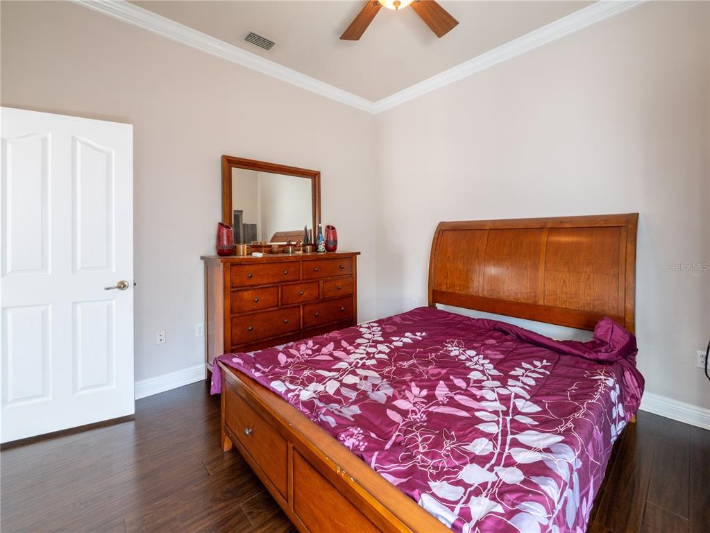 1488 Southwest 84th Terrace Gainesville, FL 32607 - Photo 22 of 31 a bedroom with a bed and a dresser