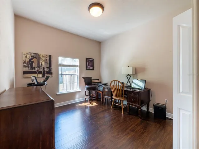 a view of a workspace with furniture and a window