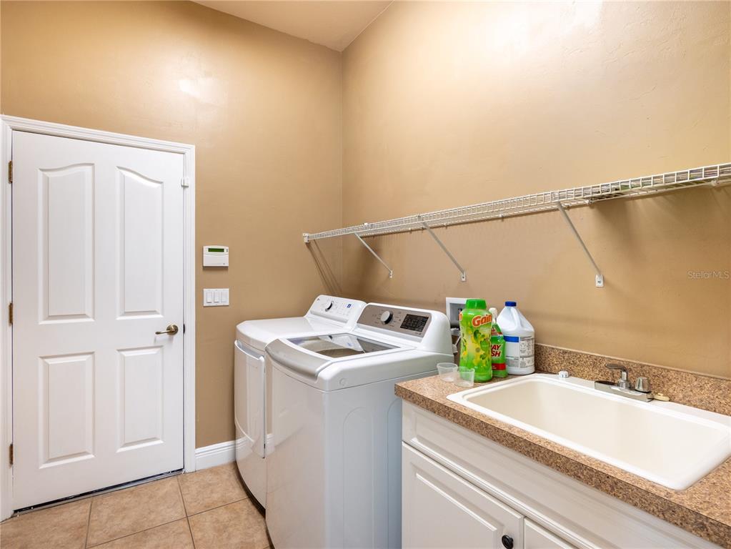 1488 Southwest 84th Terrace Gainesville, FL 32607 - Photo 30 of 31 a utility room with dryer and washer
