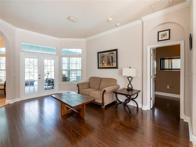 a living room with furniture and wooden floor
