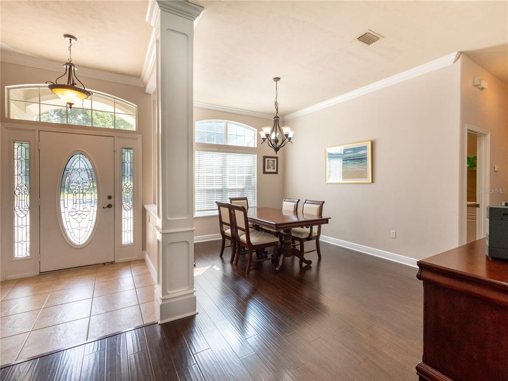 1488 Southwest 84th Terrace Gainesville, FL 32607 - Photo 5 of 31 a view of a dining room with furniture window and wooden floor