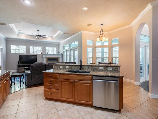 a large kitchen with kitchen island a sink table and chairs