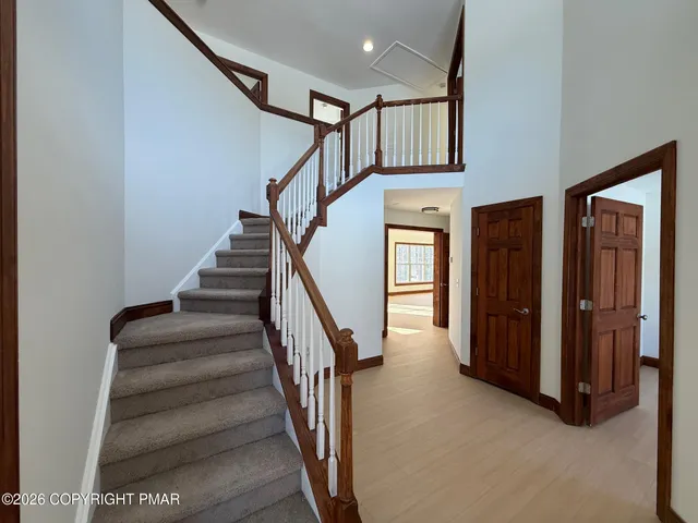 a view of staircase with lots of frames on wall and stairs