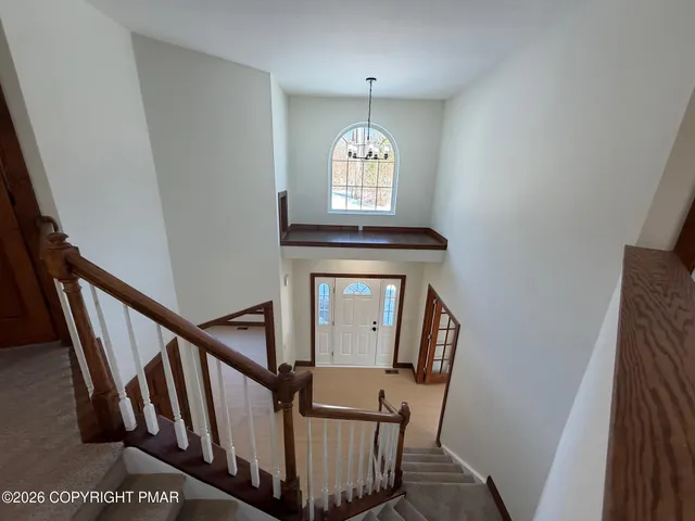 a view of a hallway with wooden floor and entryway