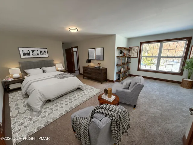 a bedroom with a bed couch and a window