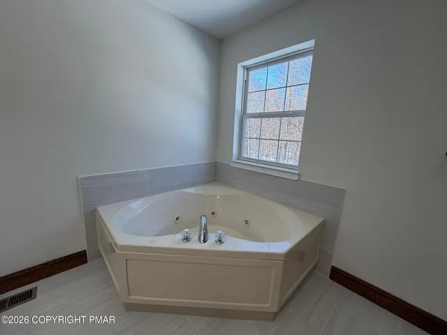 a white bath tub sitting in a bathroom