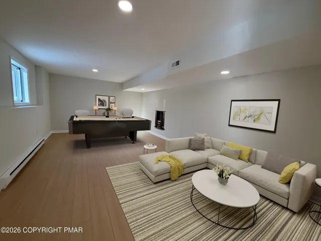 a living room with furniture and a wooden floor