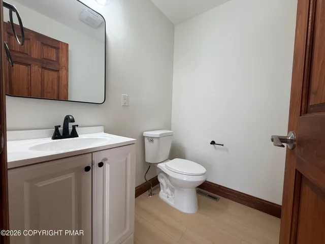 a bathroom with a sink toilet and a mirror