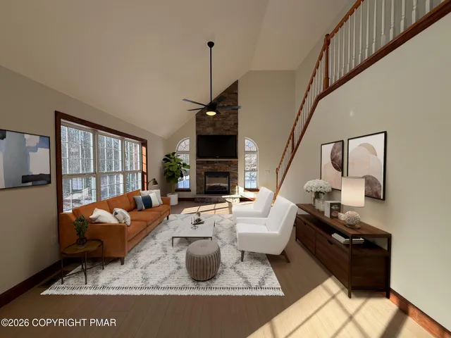 a living room with furniture fireplace and a large window