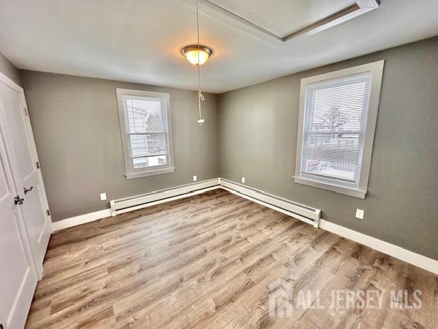 15 Doughty Street, Unit C Raritan, NJ 08869 - Photo 14 of 18 a view of an empty room with a window and wooden floor