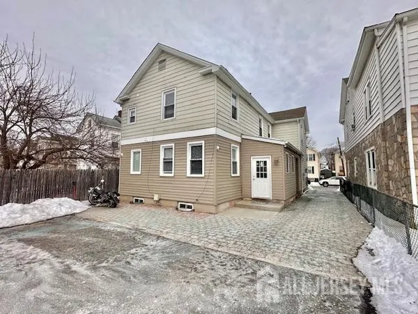 a view of a house with a yard covered in snow