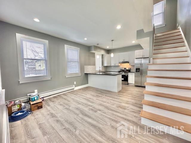 15 Doughty Street, Unit C Raritan, NJ 08869 - Photo 5 of 18 a view of a kitchen with wooden floor and electronic appliances